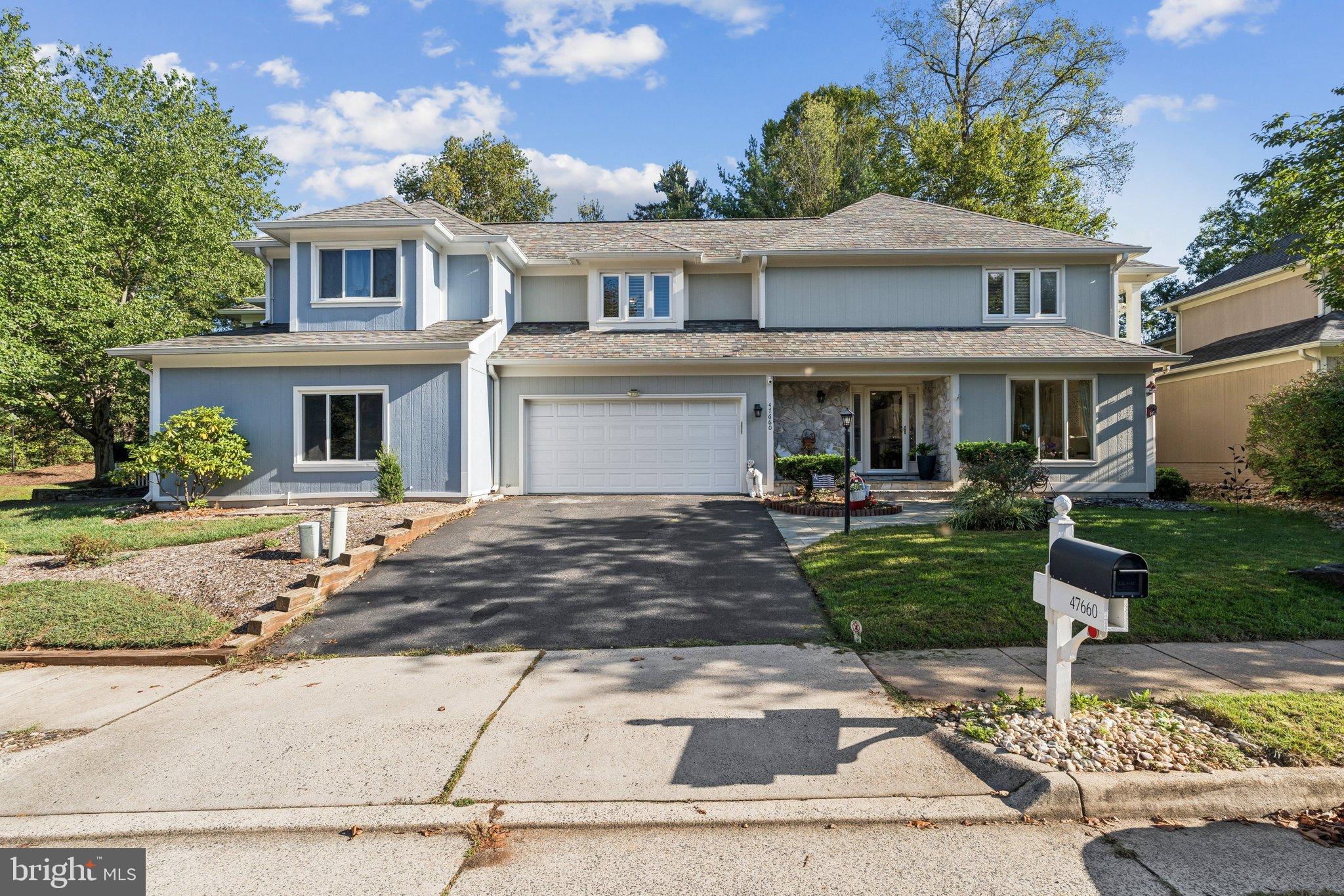 47660 Pennrun Way Sterling, VA 20165 - Photo 2 of 55 a front view of a house with garden and trees