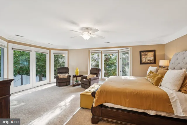 a spacious bedroom with a large bed and a large window