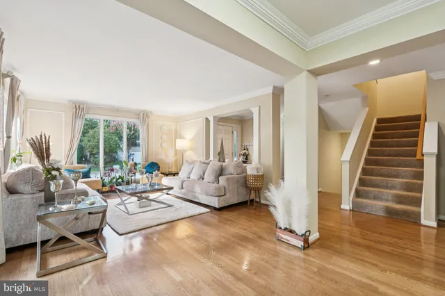 a view of a hallway with wooden floor and closet area
