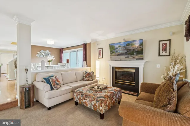 a very nice looking dining room with kitchen island furniture a large window and a view of living room