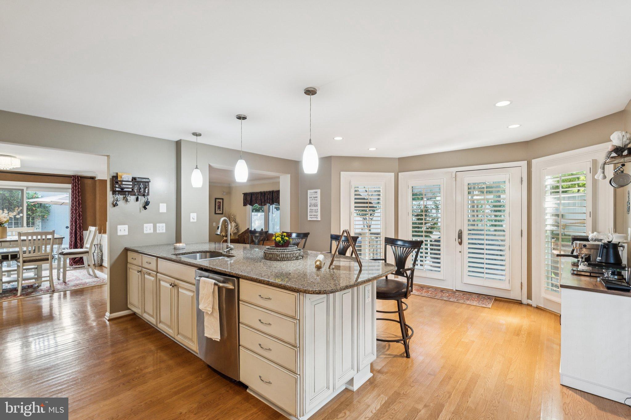 47660 Pennrun Way Sterling, VA 20165 - Photo 43 of 55 a very nice looking dining room with kitchen island furniture a large window and a view of living room