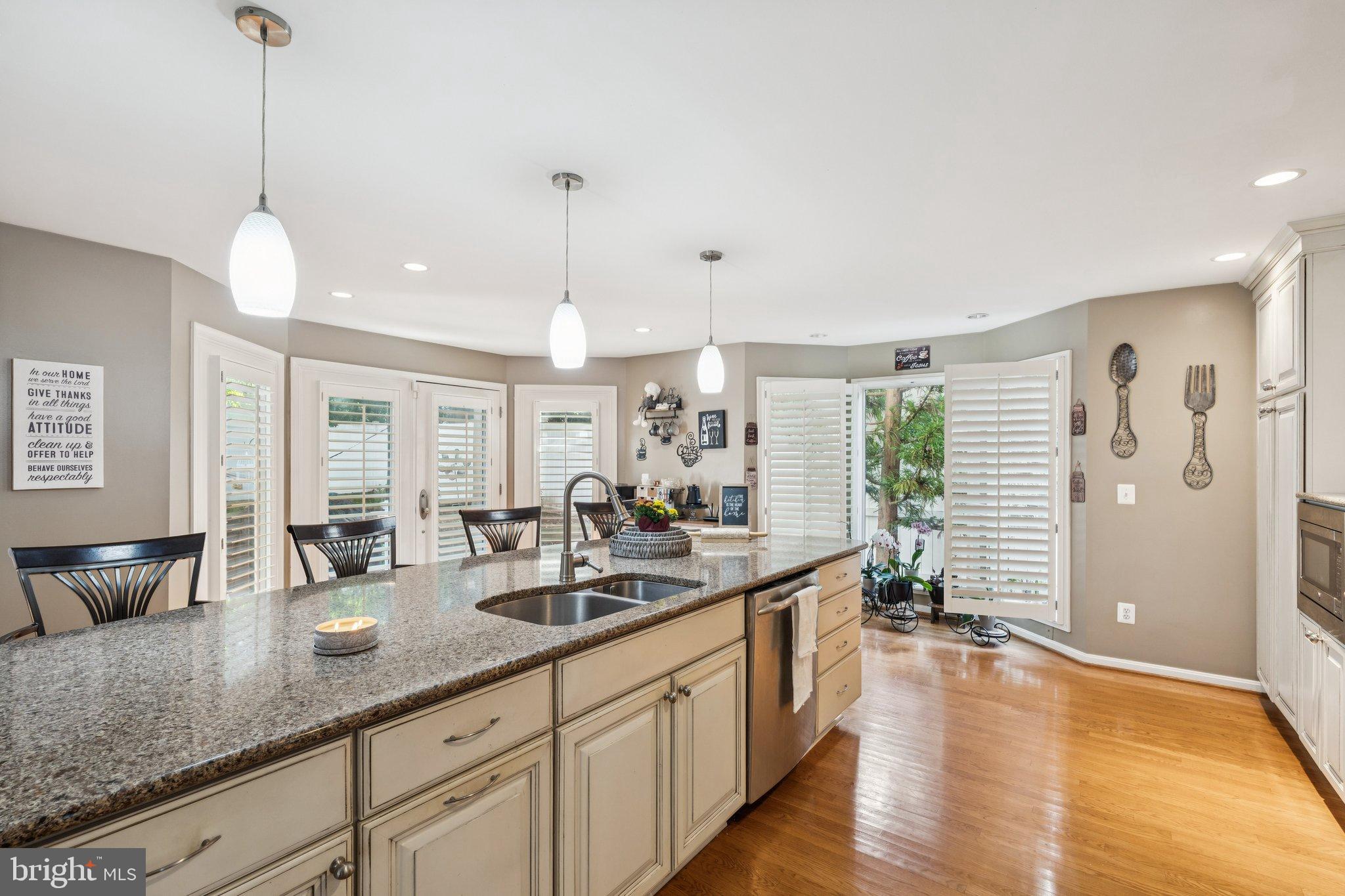 47660 Pennrun Way Sterling, VA 20165 - Photo 44 of 55 a open kitchen with stainless steel appliances granite countertop a sink a oven and a wooden floors