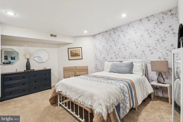 a bedroom with a bed and a dresser