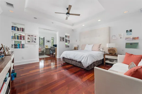 a bedroom with furniture and a wooden floor