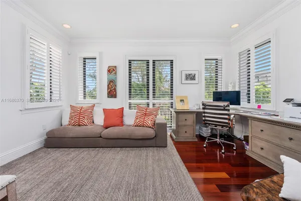 a living room with furniture and large windows