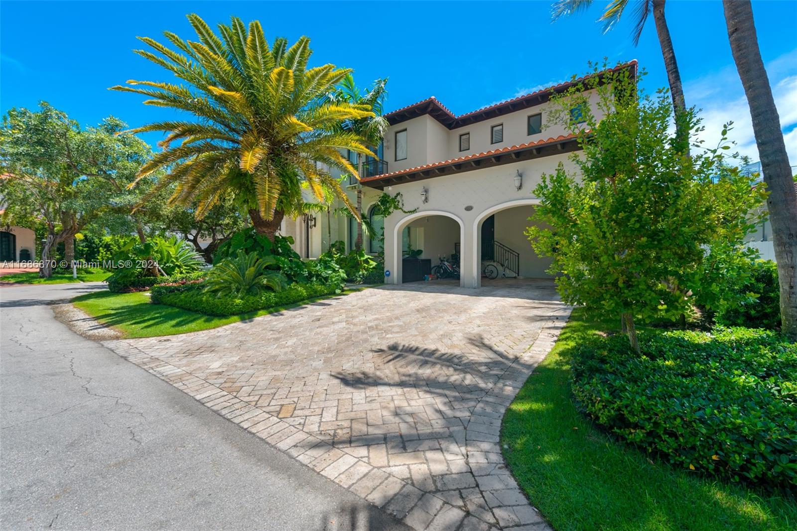250 Buttonwood Drive Key Biscayne, FL 33149 - Photo 2 of 39 a front view of a house with a garden