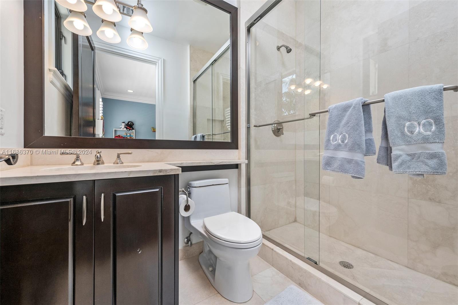 250 Buttonwood Drive Key Biscayne, FL 33149 - Photo 24 of 39 a bathroom with a sink a toilet and shower