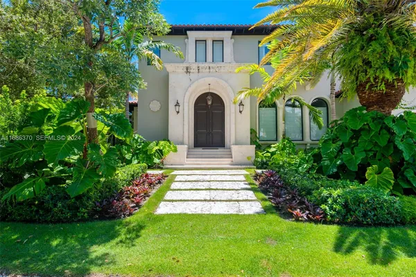a front view of a house with a garden