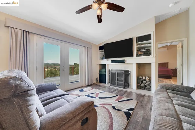 a dining room with furniture potted plants and wooden floor