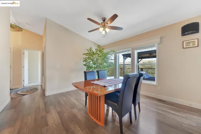a living room with furniture ceiling fan and a window