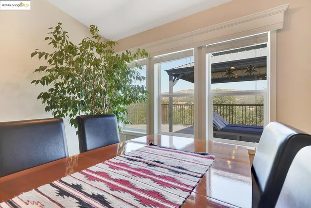 a dining room with furniture and a potted plant
