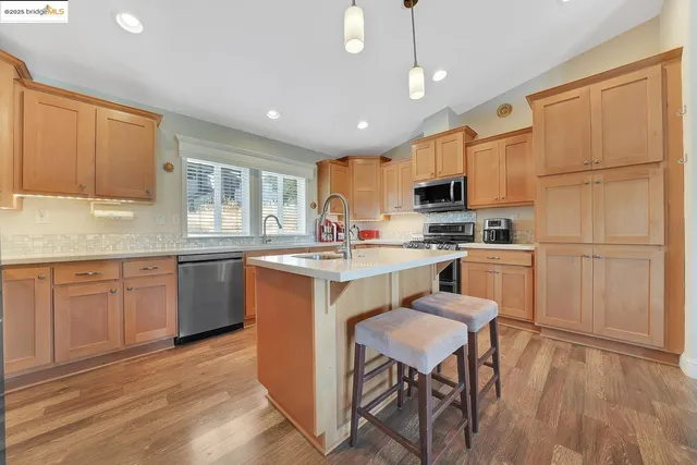 a kitchen with a sink a stove and cabinets