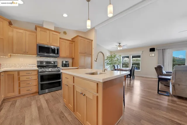a kitchen with granite countertop white cabinets sink and window