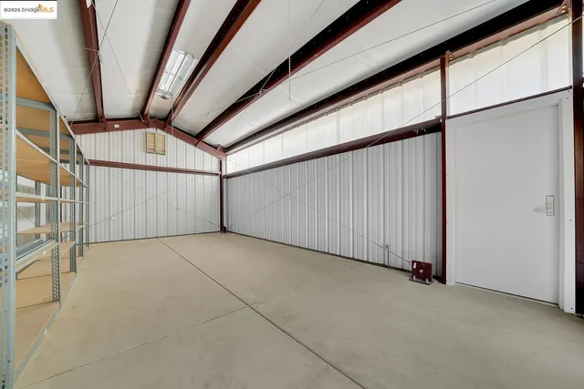 a view of a house with a yard and large tree