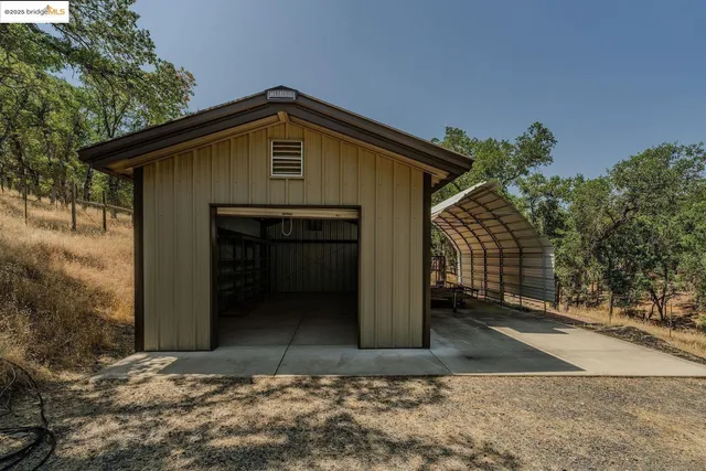 a view of a roof deck with two chairs and a table