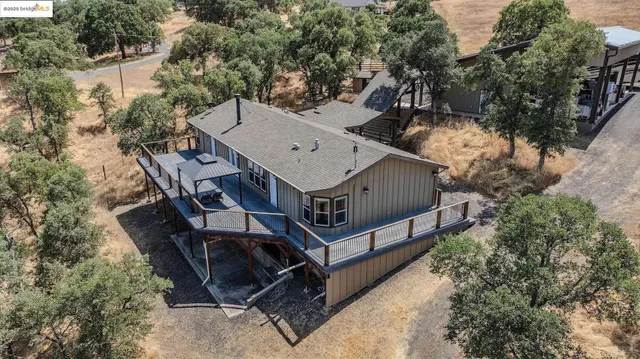 a view of a wooden house with a yard