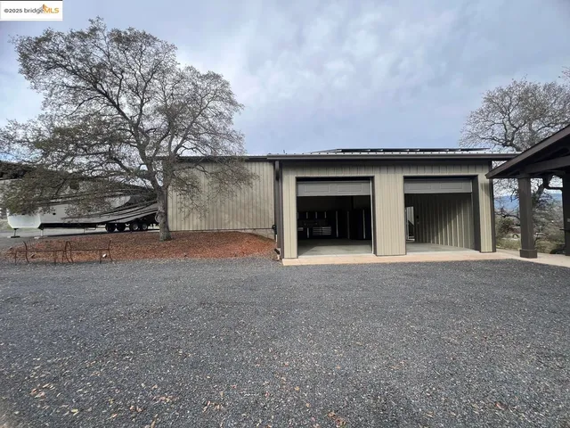 a view of a house with a yard and garage