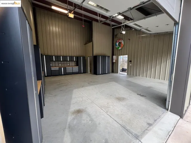a view of a room with a ceiling fan