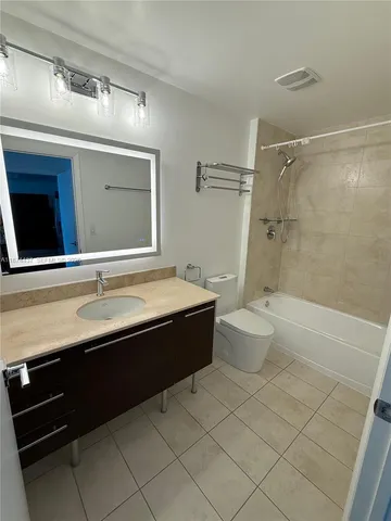 a bathroom with a sink a toilet and a bathtub
