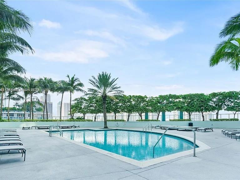 1900 North Bayshore Drive, Unit 3507 Miami, FL 33132 - Photo 16 of 22 a swimming pool with outdoor seating and yard