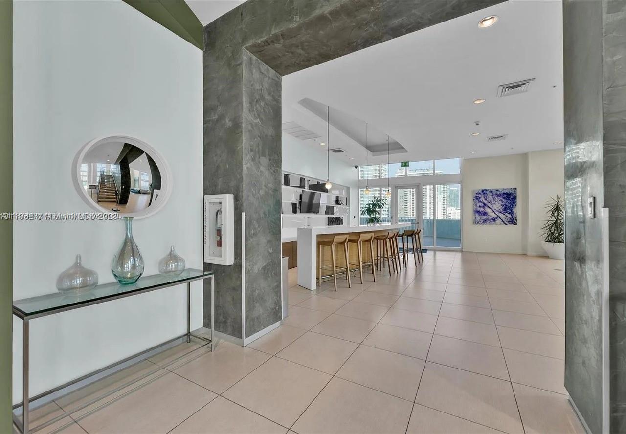 1900 North Bayshore Drive, Unit 3507 Miami, FL 33132 - Photo 17 of 22 a kitchen with stainless steel appliances granite countertop a refrigerator and a stove top oven