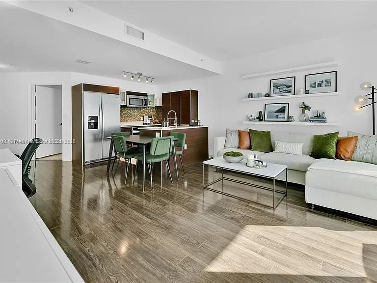 1900 North Bayshore Drive, Unit 3507 Miami, FL 33132 - Photo 2 of 22 a living room with furniture and a flat screen tv