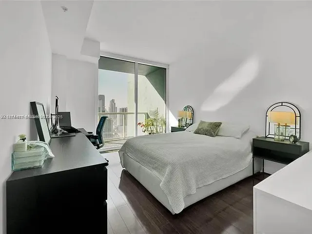 a bedroom with bed and window