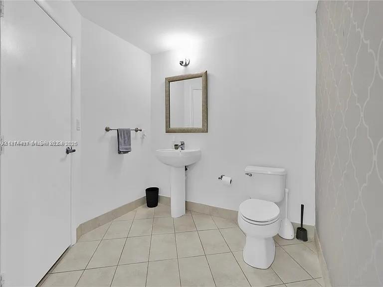 1900 North Bayshore Drive, Unit 3507 Miami, FL 33132 - Photo 9 of 22 a white toilet sitting next to a bathroom sink