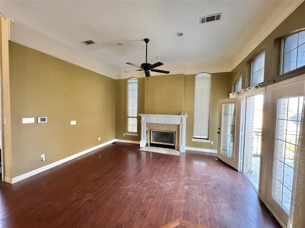a view of an empty room with a fireplace and a window