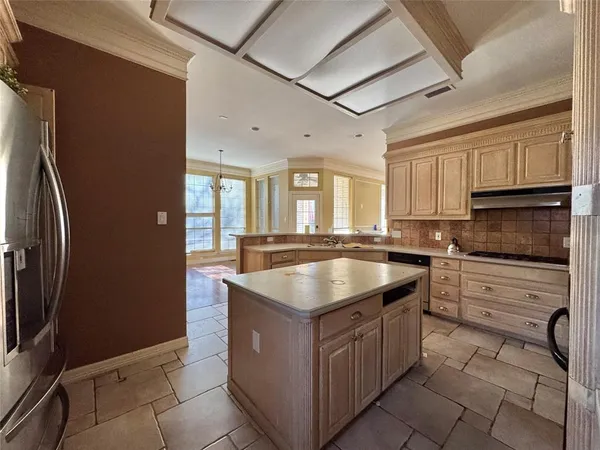a kitchen with stainless steel appliances granite countertop a sink a stove and a refrigerator
