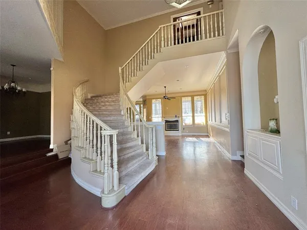 a view of staircase with lots of frames and a rug
