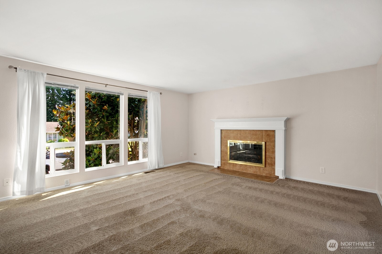 4206 Southeast 1st Place Renton, WA 98059 - Photo 3 of 25 a view of an empty room with a window and a fireplace