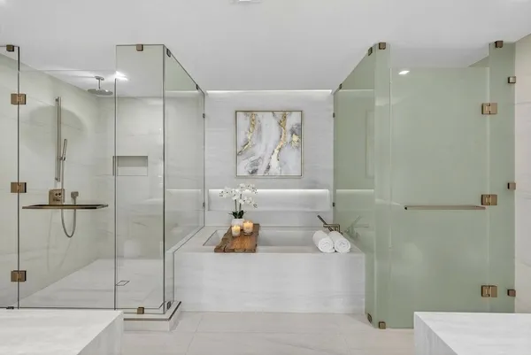 a large white kitchen with a sink and refrigerator