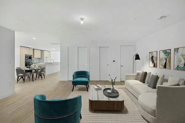 a large kitchen with stainless steel appliances a large counter top and a wooden floor
