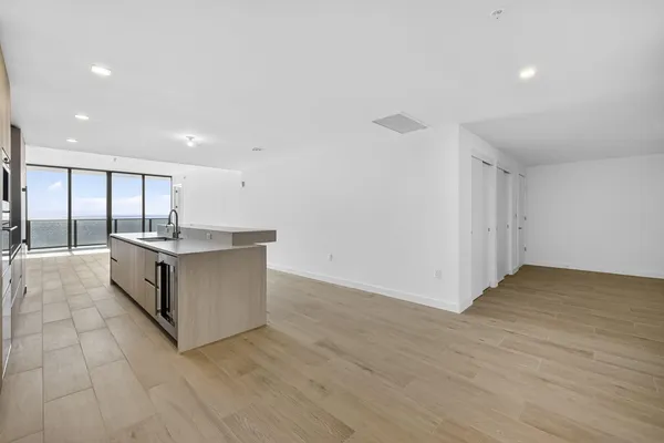 a view of an empty room and wooden floor