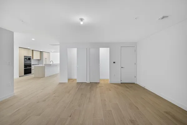 a front view of a building with a garden and plants