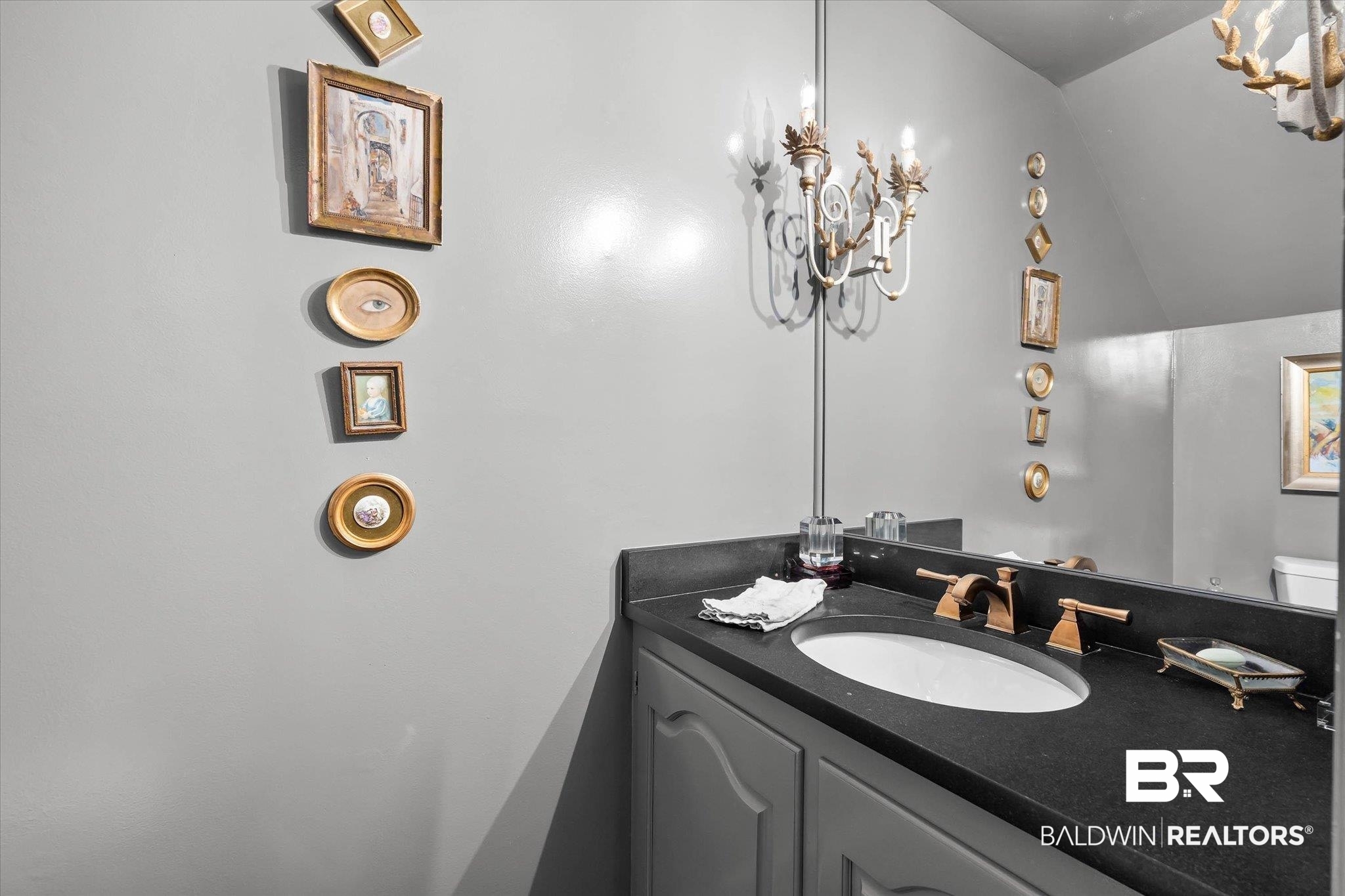 3908 Yester Place Mobile, AL 36608 - Photo 24 of 45 Vanity with a dark countertop, white oval sink, and bronze-finish faucet
