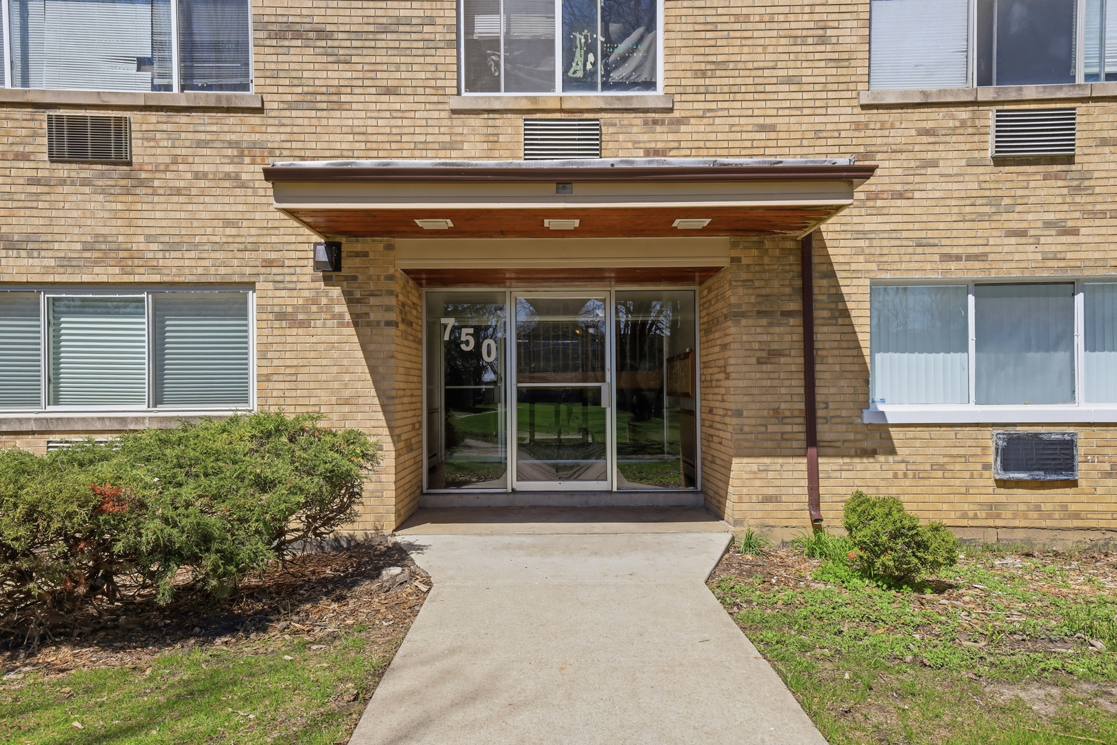 750 Dempster Street, Unit CG4 Mount Prospect, IL 60056 - Photo 2 of 20 a front view of a house with a yard