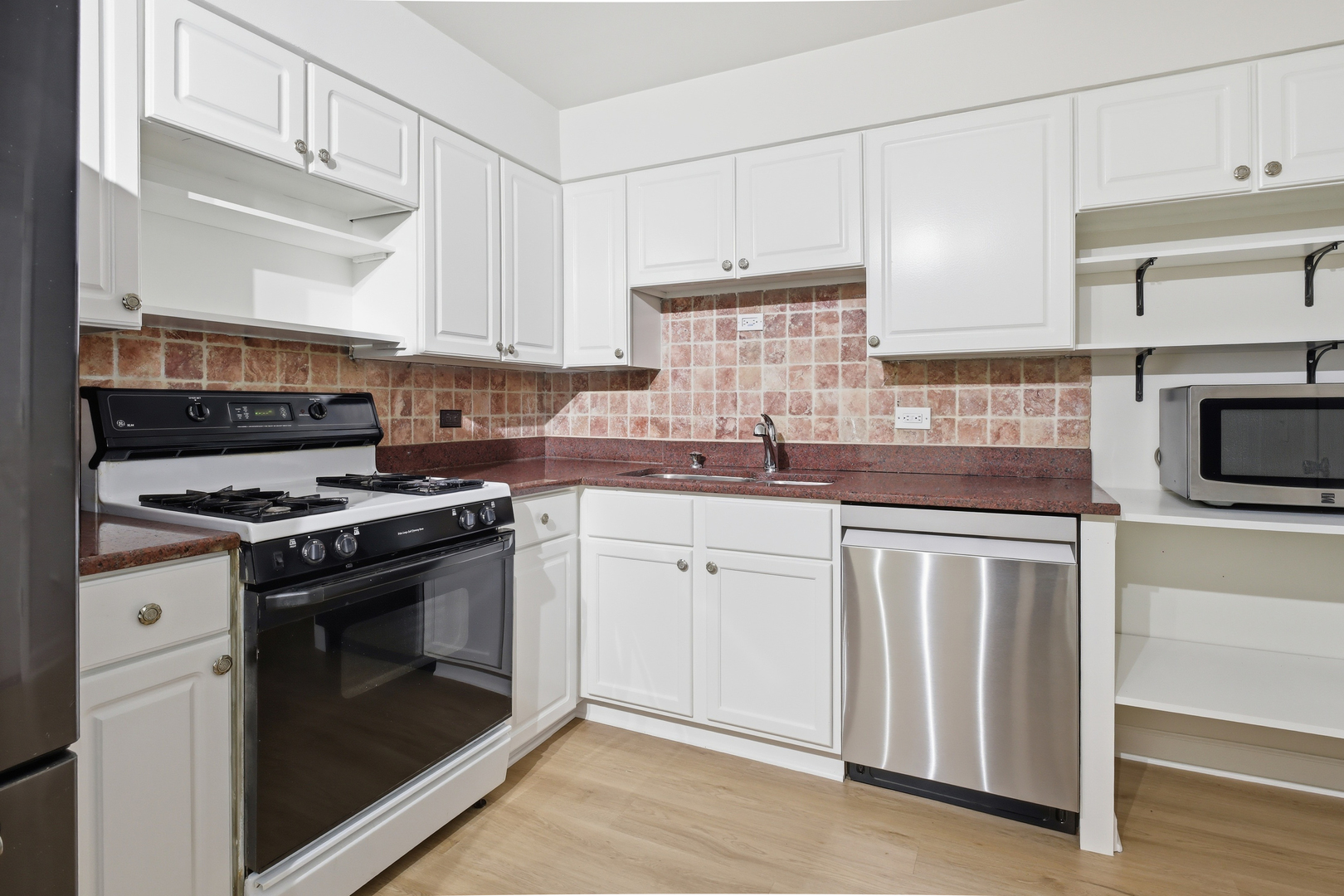 750 Dempster Street, Unit CG4 Mount Prospect, IL 60056 - Photo 3 of 20 a kitchen with cabinets stainless steel appliances and sink