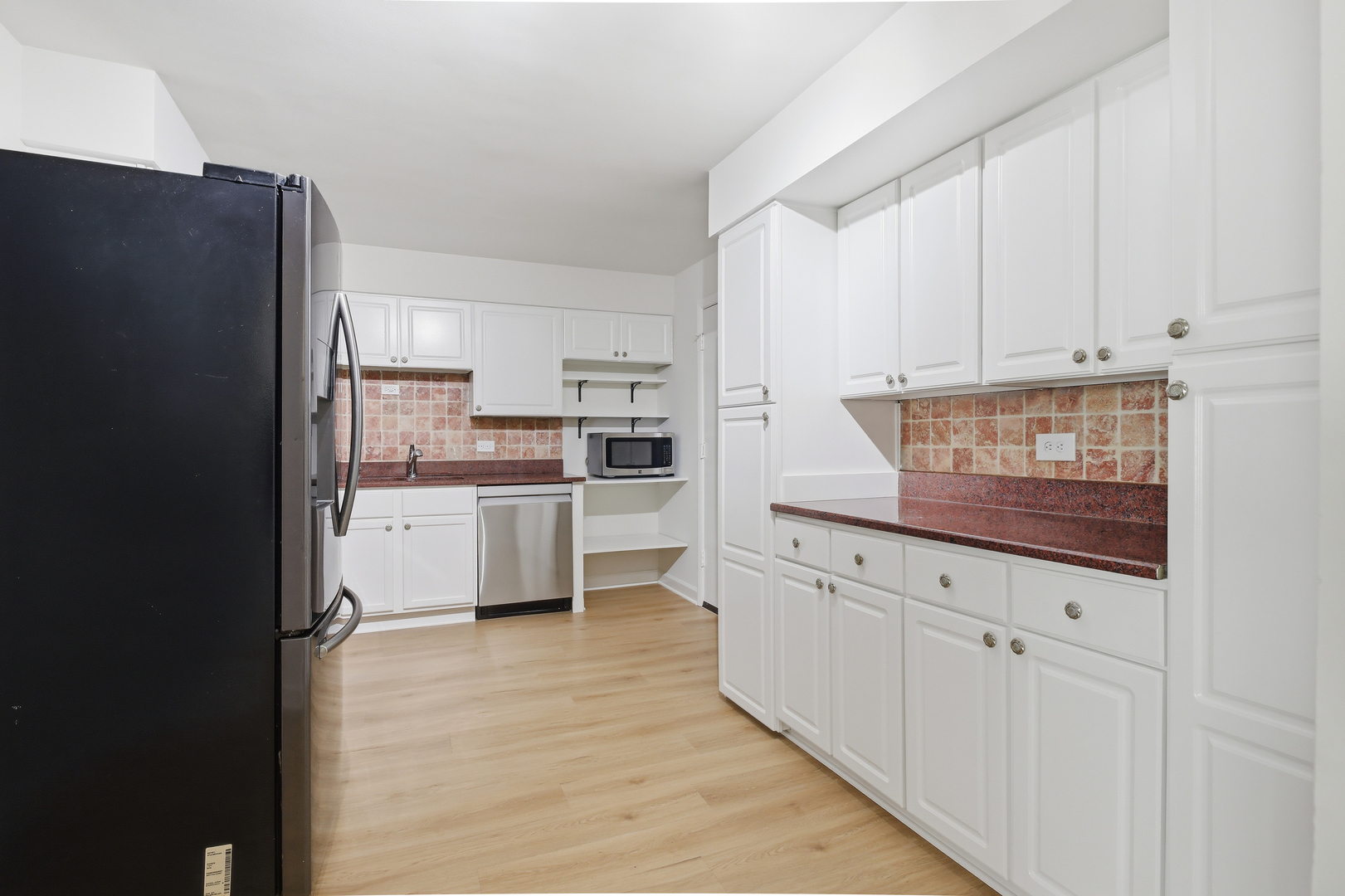 750 Dempster Street, Unit CG4 Mount Prospect, IL 60056 - Photo 4 of 20 a kitchen with white cabinets and refrigerator