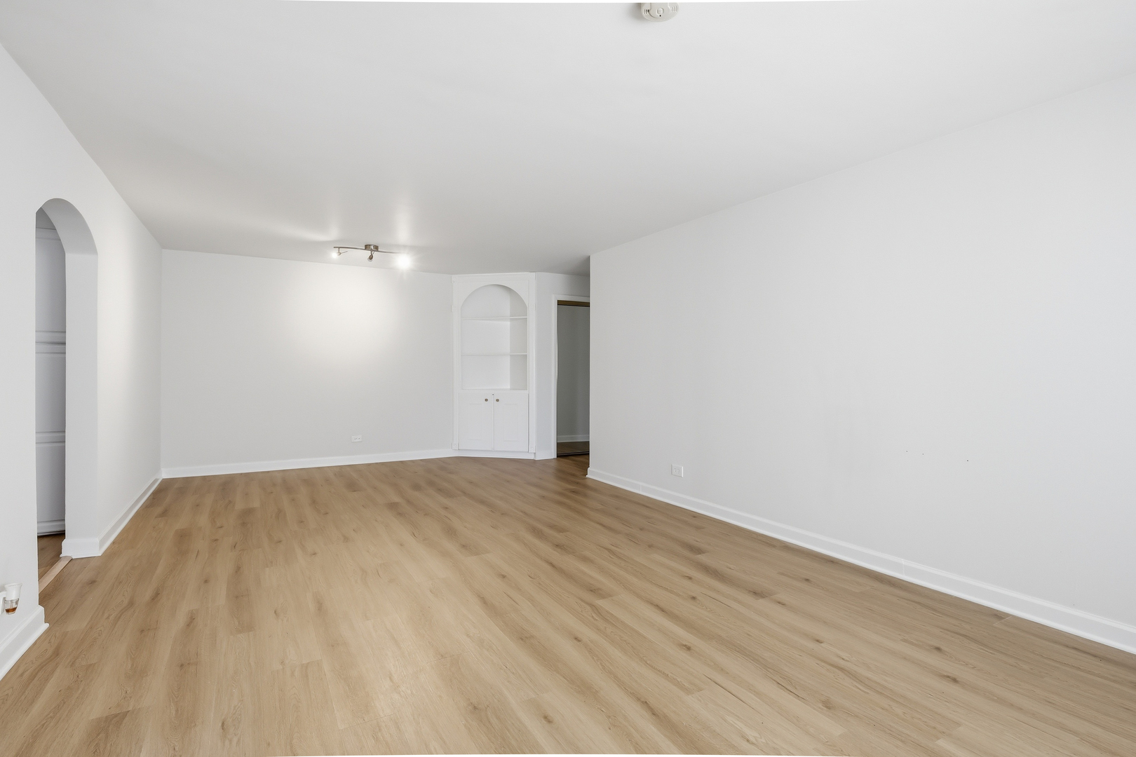 750 Dempster Street, Unit CG4 Mount Prospect, IL 60056 - Photo 5 of 20 a view of an empty room with wooden floor