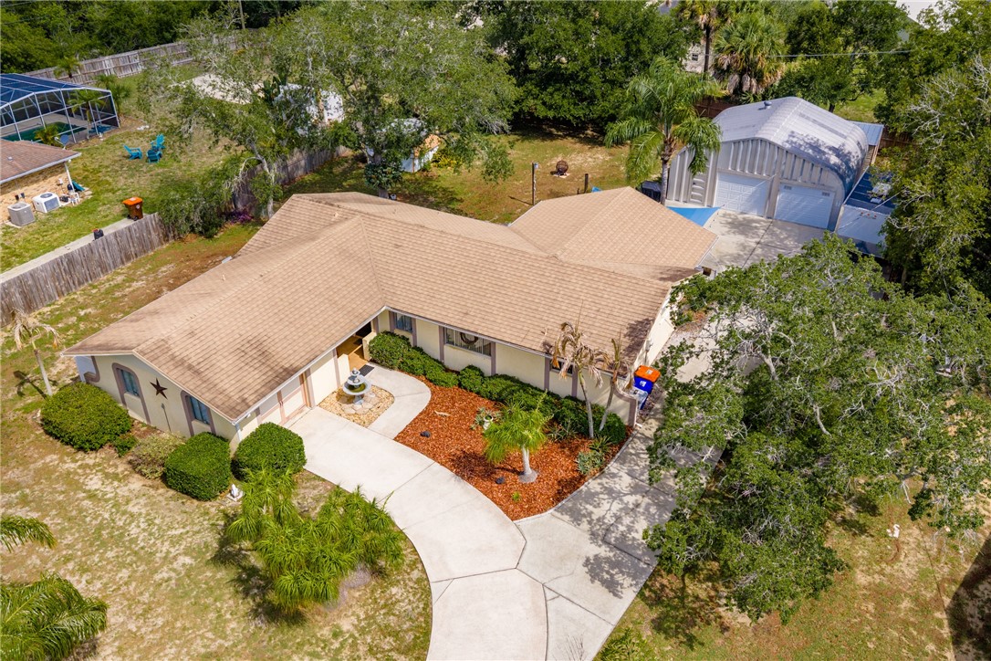 7666 134th Street Sebastian, FL 32958 - Photo 1 of 35 an aerial view of a house with a yard and garden