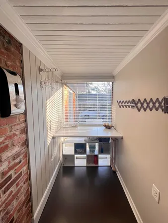 a view of a room with window and wooden floor