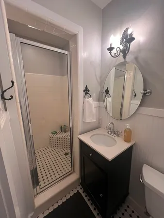 a bathroom with a sink vanity and a mirror