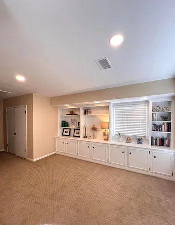 a large white room with closet and windows