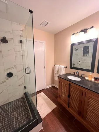 a bathroom with a sink a toilet and shower