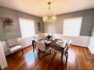 a view of a dining room with furniture wooden floor and chandelier