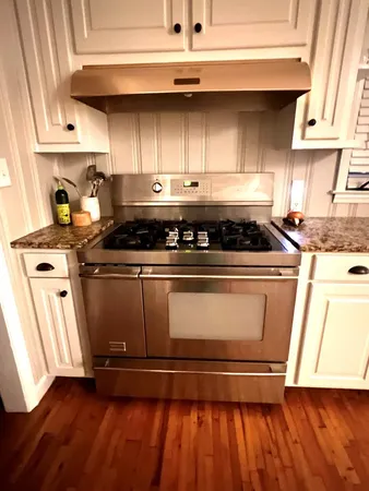 a stove top oven sitting inside of a kitchen