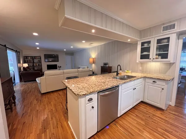 a spacious kitchen with stainless steel appliances granite countertop a lot of counter space and a sink