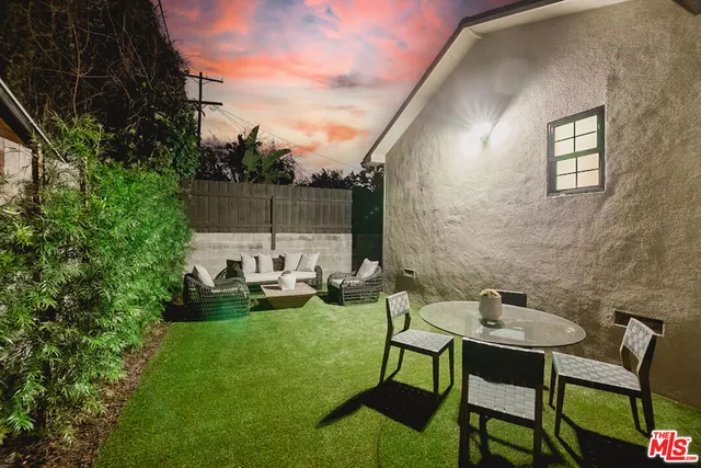 a view of a patio with table and chairs and potted plants